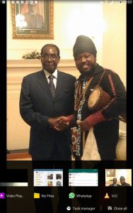 Blak Rasta In a Handshake with President Robert Mugabe