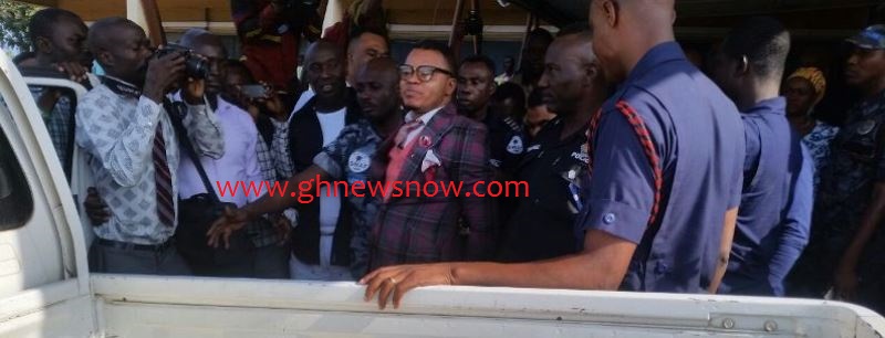 Daniel Obinim being led into a police pickup after his meeting with the Tema DOVSSU boss