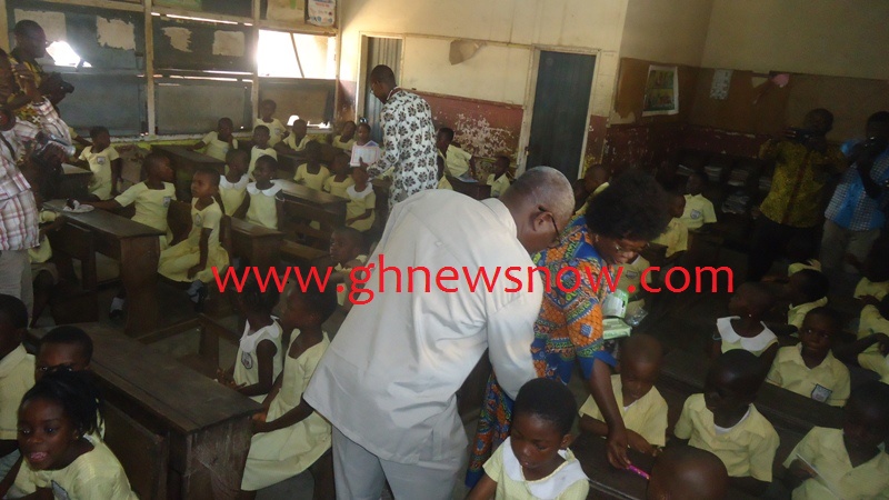 isaac-odamtten-far-left-and-mrs-frempong-kore-distributing-some-writing-materials-to-the-basic-one-pupils-of-star-basic-school-tema-community-5