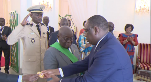 Senegalese President Macky Sall decorating Nana Addo